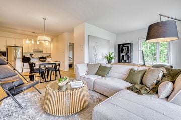Gatineau apartment for rent - A modern living room with a white couch and a wooden coffee table.