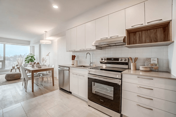 Modern kitchen with white cabinets and dining area