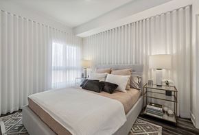 Gatineau apartment for rent - Modern bedroom with neutral bedding and curtains at Horizon Apartments, Quebec, J9A 0G9