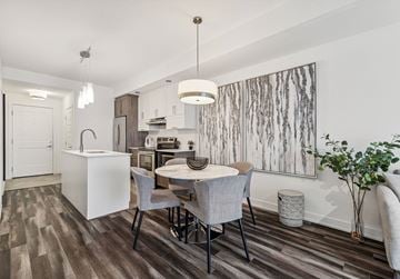 Gatineau apartment for rent - A modern kitchen with a dining table and chairs.
