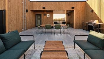 A wooden deck with a table and chairs.