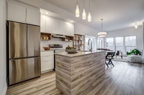 Gatineau apartment for rent - A modern kitchen with a wooden island and stainless steel appliances.