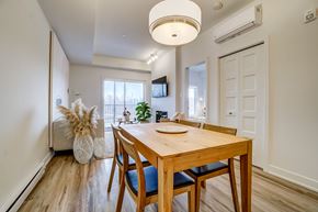 Gatineau apartment for rent - A dining room with a wooden table and chairs.