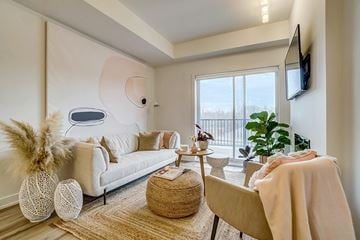 Gatineau apartment for rent - A living room with a white couch and a large window.
