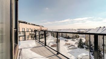 Winter balcony with glass railing overlooking courtyard