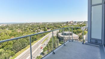 High rise balcony overlooking highway and cityscape