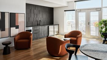 A modern living room with a dining table and chairs.