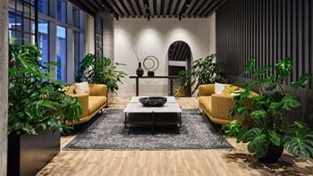 A living room with a yellow sofa and a coffee table.