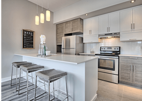 Gatineau apartment for rent - A modern kitchen with a white countertop and stainless steel appliances.