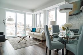 Ottawa apartment for rent - A modern dining room with a glass table and grey chairs.