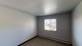 Madison apartment for rent - A room with a window and carpeted floor.