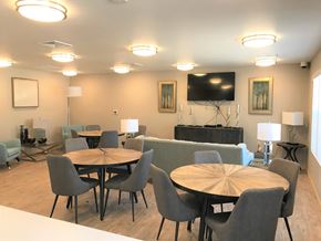 Sun Prairie apartment for rent - A modern dining room with a round table and grey chairs.