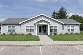 Sun Prairie apartment for rent - A small building with a grey roof and a white door.