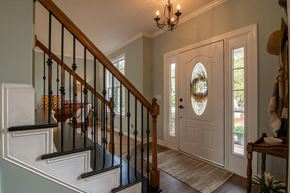 Halton Hills apartment for rent - A staircase with a black railing and a light brown carpet.