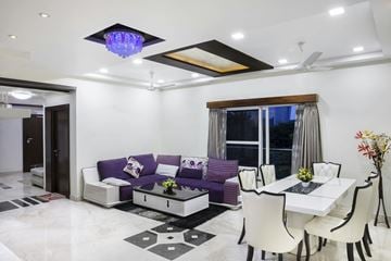Winnipeg apartment for rent - A modern living room with a purple couch and a white dining table.
