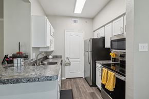 Arlington apartment for rent - A kitchen with a black refrigerator and stove.