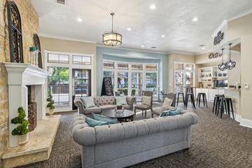 Arlington apartment for rent - A living room with a grey couch and a fireplace.