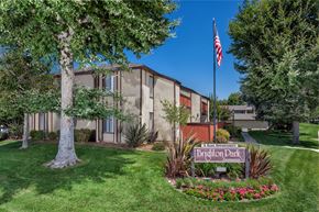 Claremont apartment for rent - A building with a sign that says "Brighton Park Apartments" in front of it.