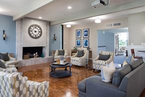 Huntington Beach apartment for rent - A common room with a fireplace and a large clock on the wall.