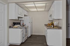 Pomona apartment for rent - A kitchen with white appliances and cabinets.