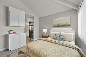 Claremont apartment for rent - A bedroom with a bed, nightstand, and a painting on the wall.