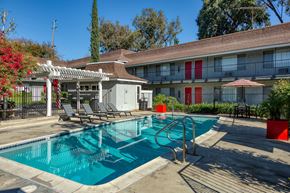 Upland apartment for rent - A pool with a slide and a sun shade.