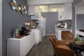 Upland apartment for rent - A modern kitchen with white appliances and brown leather chairs.