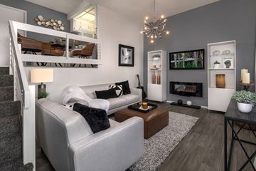 Upland apartment for rent - A modern living room with a grey couch and a fireplace.