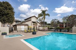 Claremont apartment for rent - A swimming pool in a residential area surrounded by trees and houses.