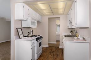 Brea apartment for rent - A kitchen with white appliances and cabinets.