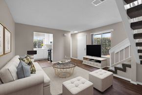 Whittier apartment for rent - A living room with a couch, a coffee table, and a staircase.