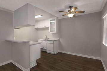 Garden Grove apartment for rent - A kitchen with white cabinets and a ceiling fan.