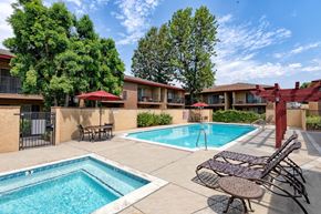 Azusa apartment for rent - A pool area with a small pool and a larger pool with chairs around it.
