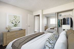 Azusa apartment for rent - A bedroom with a bed, dresser, and a painting of a plant.