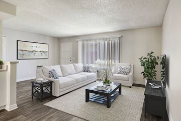 Azusa apartment for rent - A living room with a white couch, a coffee table, and a painting on the wall.