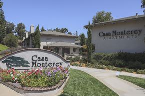 Spring Valley apartment for rent - A sign for Casa Monterey Apartments is in front of a building.