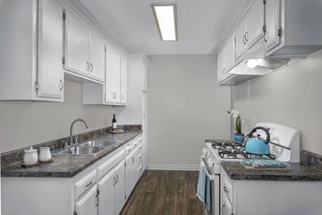Garden Grove apartment for rent - A kitchen with white cabinets and a granite countertop.