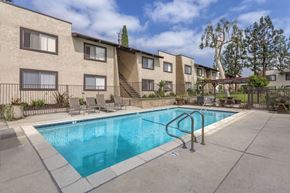 Garden Grove apartment for rent - A swimming pool in front of apartment buildings.