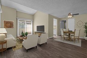 Alta Loma apartment for rent - A living room with a white couch, a wooden coffee table, and a ceiling fan.