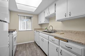 Alta Loma apartment for rent - A kitchen with white appliances and cabinets.