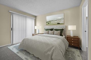 Alta Loma apartment for rent - A bedroom with a large bed and a painting above it.