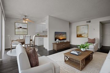 Pomona apartment for rent - A living room with a white couch and a wooden coffee table.