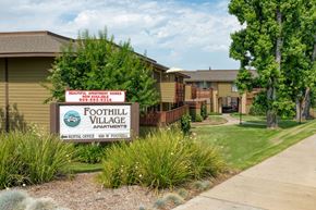 Pomona apartment for rent - A sign for Foothill Village Apartments is in front of some buildings.