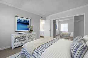 Huntington Beach apartment for rent - A bedroom with a large bed and a painting on the wall.
