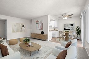 Riverside apartment for rent - A living room with a white couch, a coffee table, and a ceiling fan.