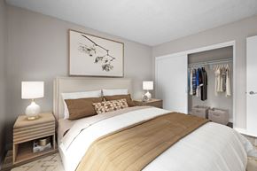 Riverside apartment for rent - A bedroom with a large bed and a wooden headboard.