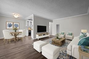 Huntington Beach apartment for rent - A living room with a white couch, a wooden coffee table, and a television.