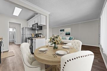 Huntington Beach apartment for rent - A modern kitchen with a dining table set for two.