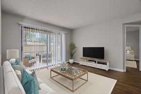 Redlands apartment for rent - A living room with a white couch, a wooden coffee table, and a flat screen TV.