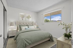 Santee apartment for rent - A bedroom with a large bed and a window overlooking a mountainous landscape.